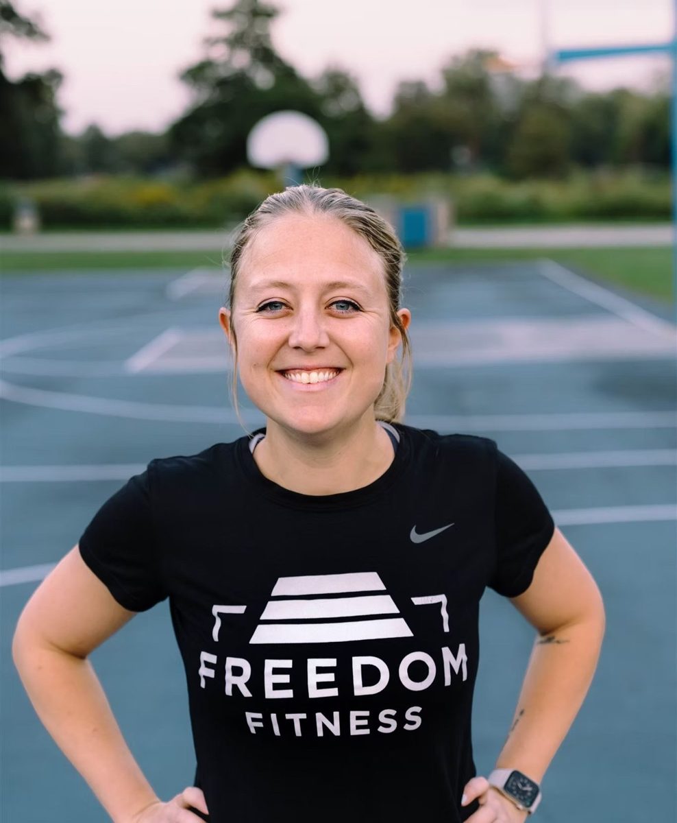 Bri in a Freedom Fitness shirt, hands on hips